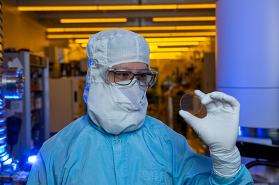  scientist holds a marvel of optical engineering, a 5-centimeter metasurface optic 